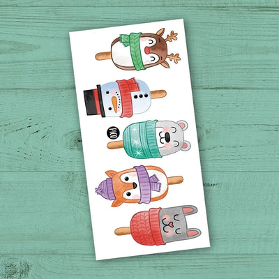 Tatouages temporaires Les gâteaux popsicles de Noël par PiCO Tatouages temporaires. Design réalisé au Québec. / Christmas cake popsicle temporary tattoos by PiCO Temporary Tattoos. Design made in Canada.